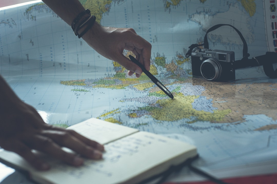 Cover image for slow travel itinerary planning with notebook, map, train ticket and coffee by a window