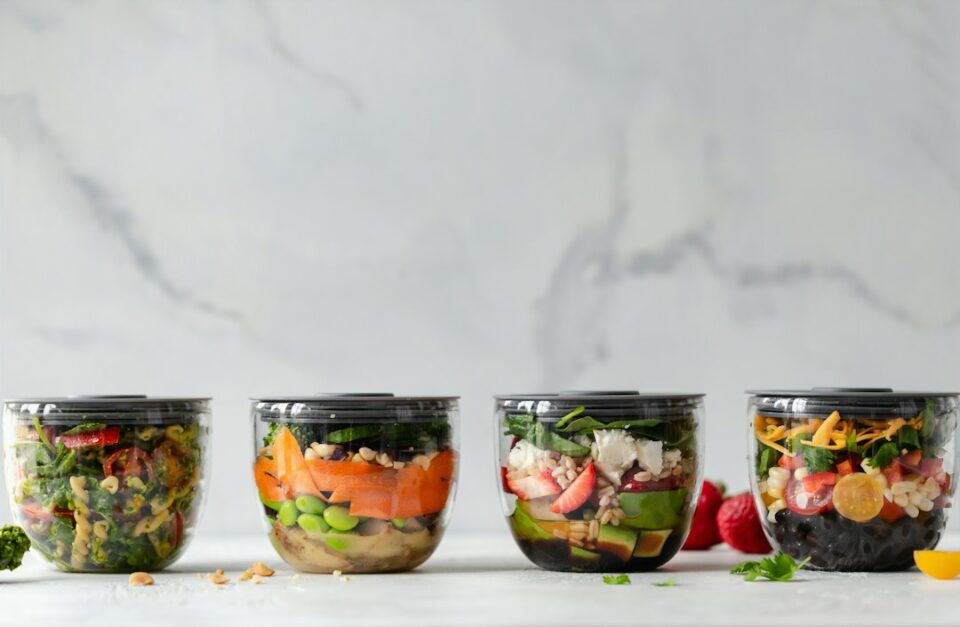 Meal Prep Containers organized in a tidy stack with colorful food and date labels