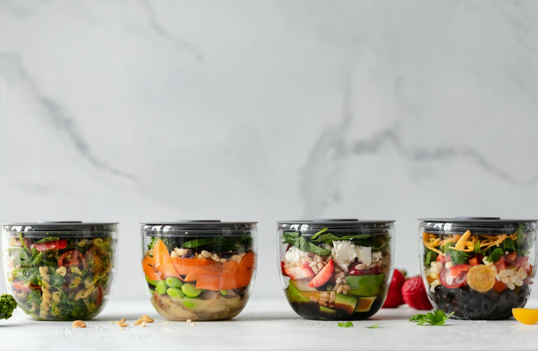 Meal Prep Containers neatly stacked with colorful food and clear date labels on a bright kitchen counter